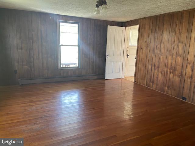 5733 Coventry Parish Road Westover, MD 21871 - Photo 10 of 27 an empty room with wooden floor and windows with curtains