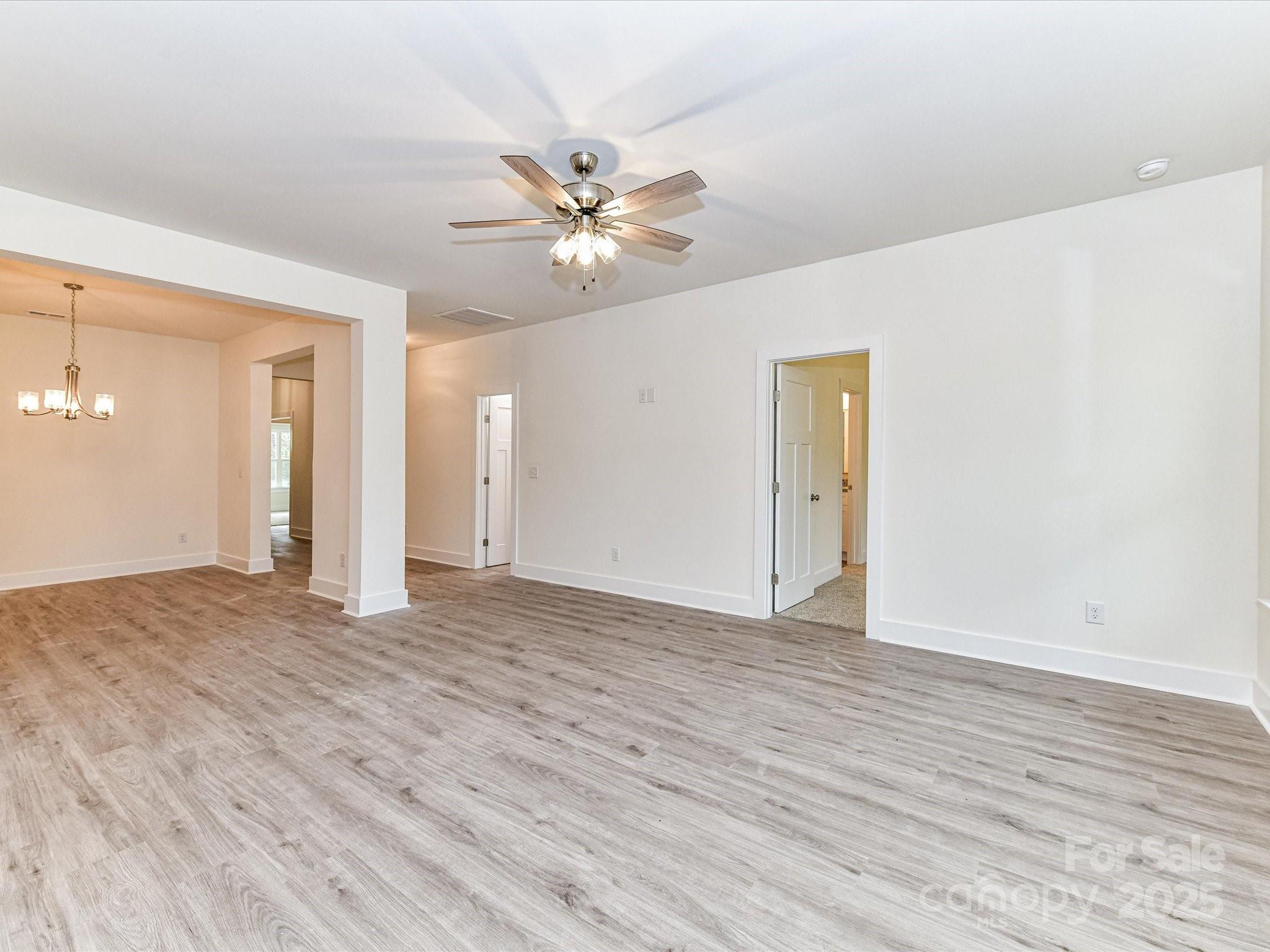 5609 Morgan Mill Road Monroe, NC 28110 - Photo 5 of 22 a view of empty room with wooden floor and ceiling fan