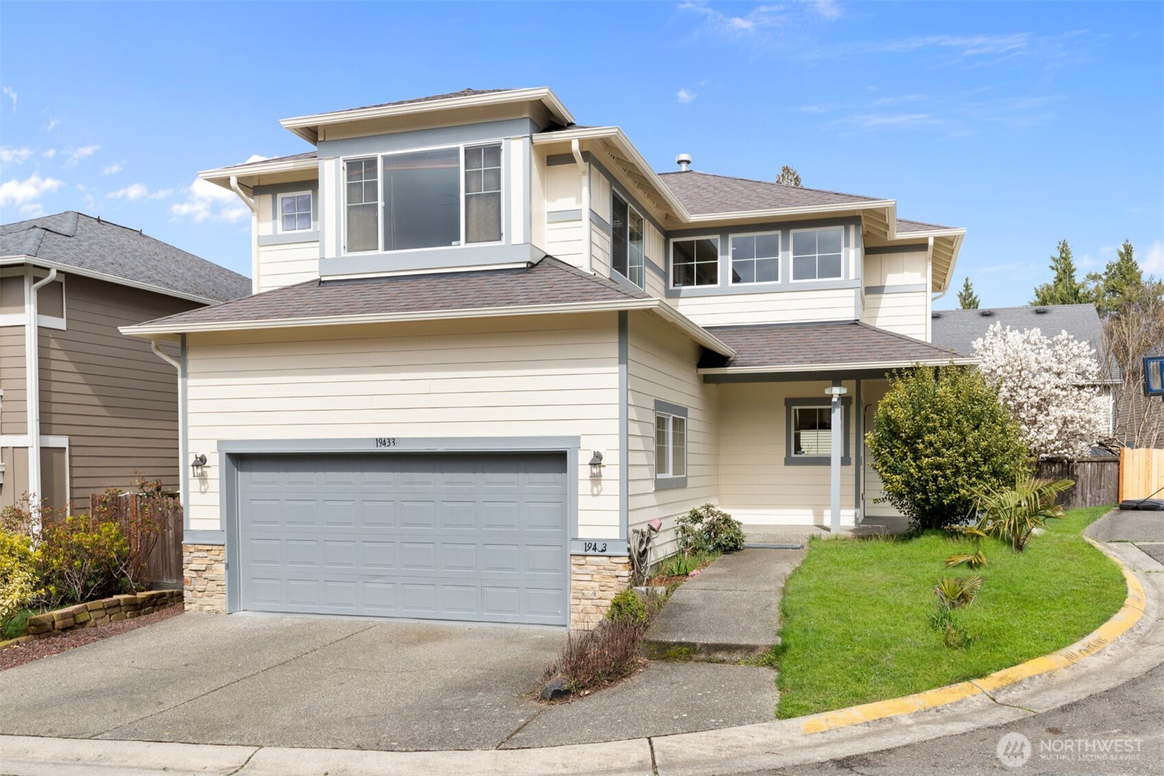 a front view of a house with a yard and garage