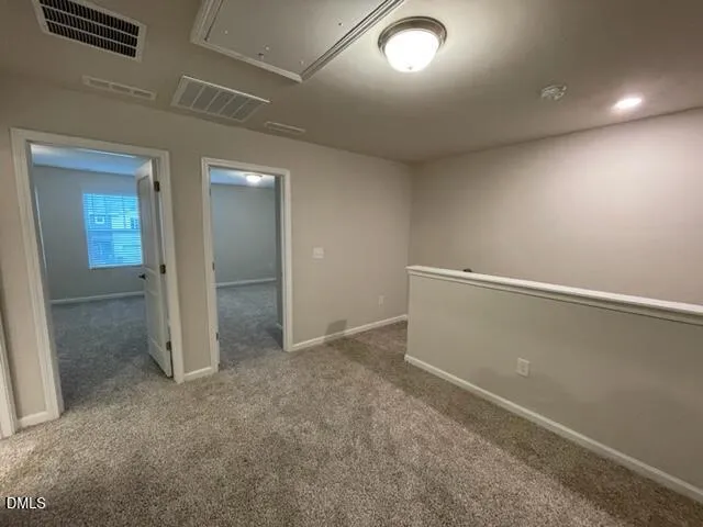 an empty room with mirror and entrance