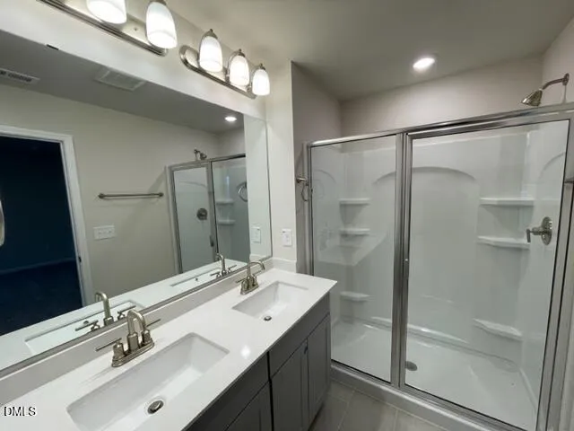 a bathroom with a sink double vanity and a mirror
