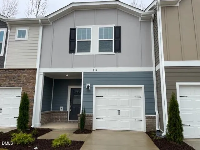 a view of kitchen with kitchen island stainless steel appliances refrigerator stove microwave and cabinets