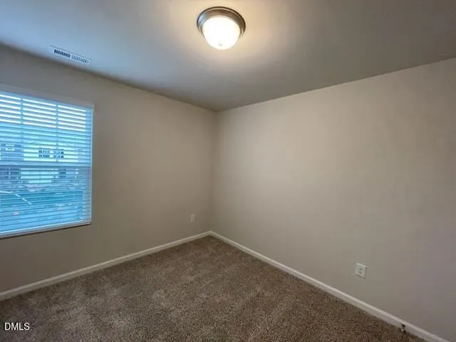 an empty room with a empty space and windows