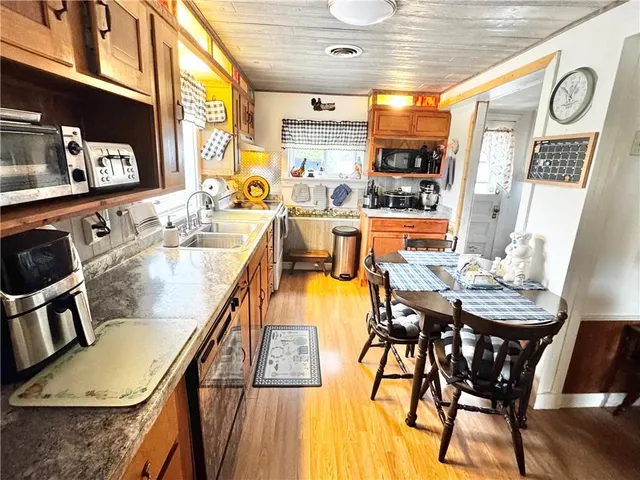 a dining room with furniture a rug and wooden floor