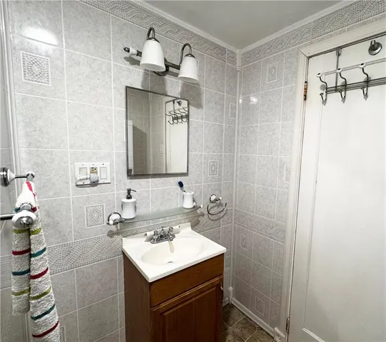 a bathroom with a sink mirror and a shower