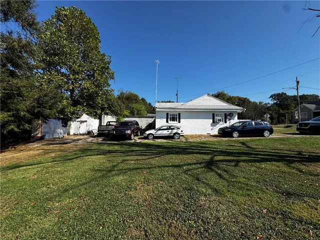 a front view of a house with a yard table and chairs
