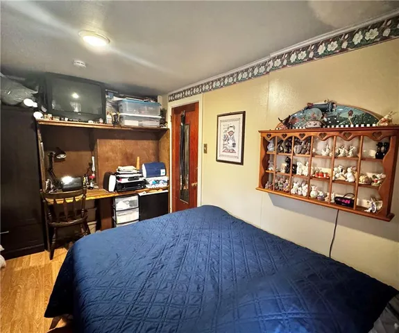 a kitchen with stainless steel appliances wooden floor and breakfast area