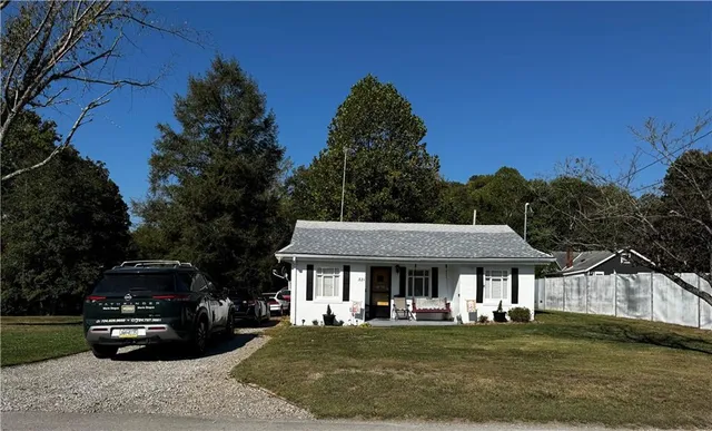 a front view of a house with a garden