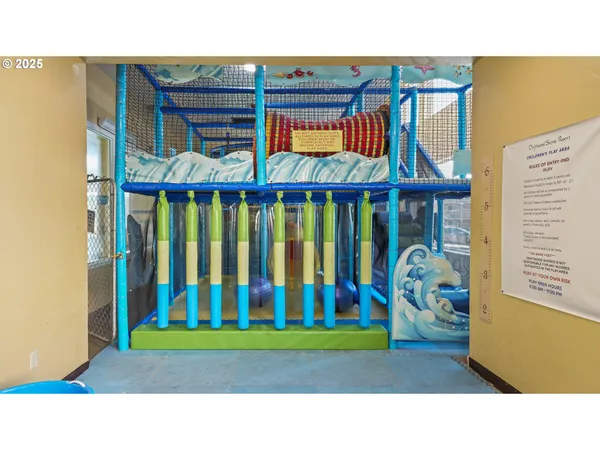 a kitchen filled with stainless steel appliances kitchen island granite countertop a table chairs and a stove