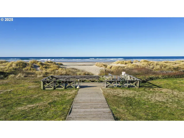 a open area with lawn chairs and ocean view