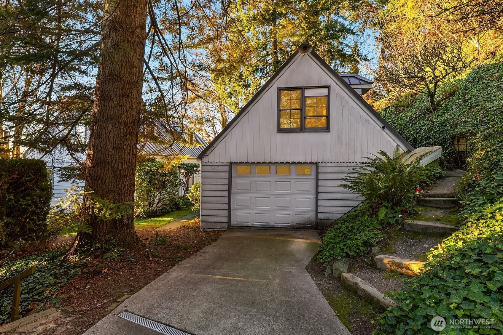 8025 West Mercer Way Mercer Island, WA 98040 - Photo 26 of 36 a front view of a house with a yard