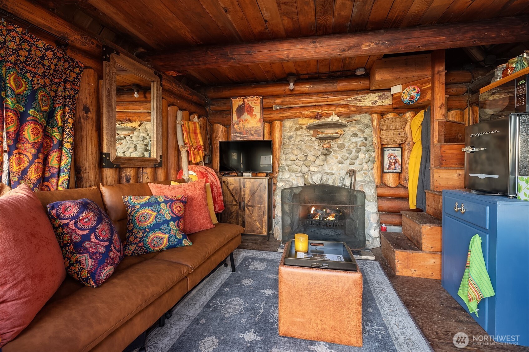 8025 West Mercer Way Mercer Island, WA 98040 - Photo 29 of 36 a living room with furniture fireplace and flat screen tv