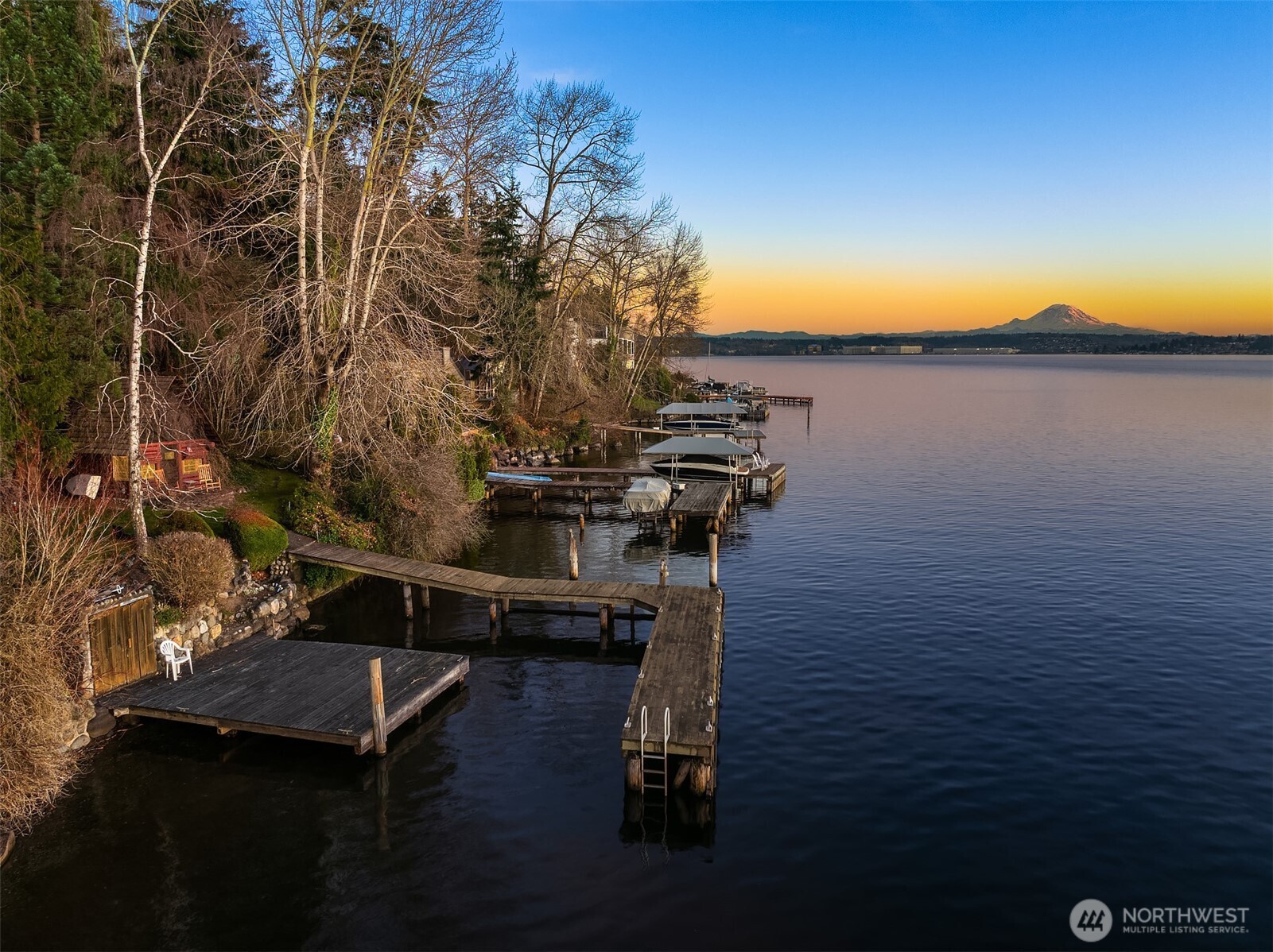 8025 West Mercer Way Mercer Island, WA 98040 - Photo 3 of 36 a view of a lake with sunset