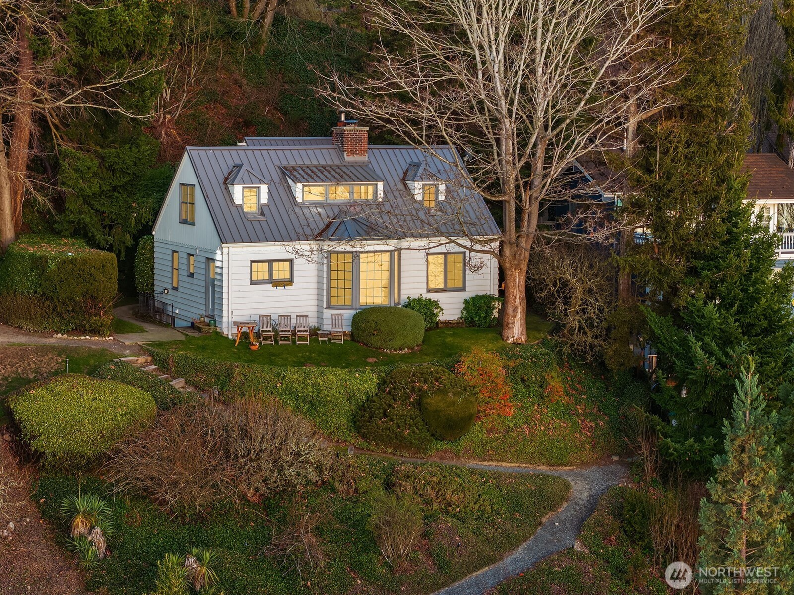 8025 West Mercer Way Mercer Island, WA 98040 - Photo 6 of 36 a front view of a house with a yard