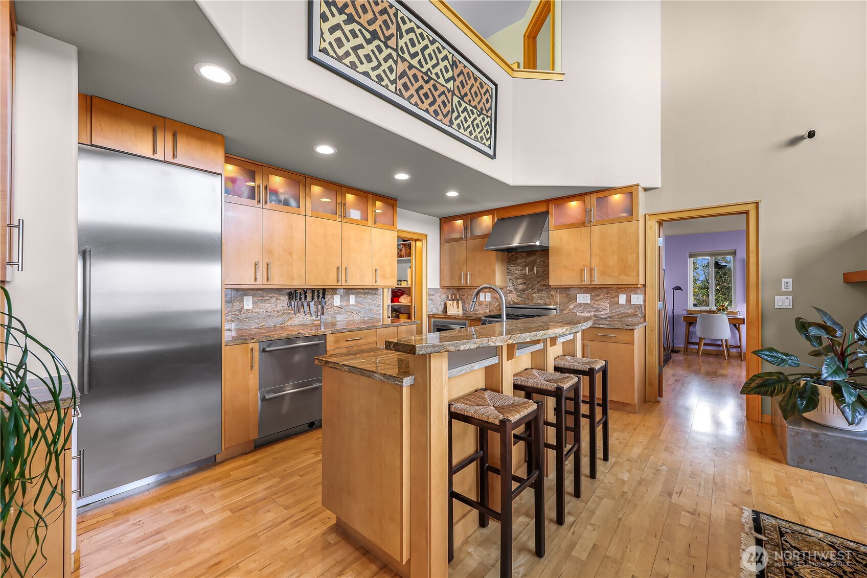 106 North State Street Bellingham, WA 98225 - Photo 11 of 34 a kitchen with stainless steel appliances kitchen island granite countertop a table chairs and a refrigerator