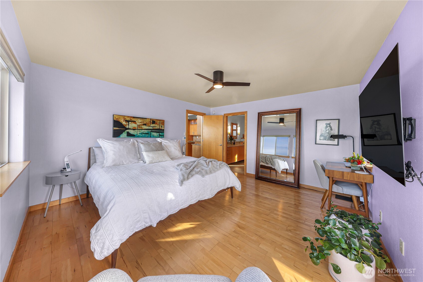 106 North State Street Bellingham, WA 98225 - Photo 14 of 34 a spacious bedroom with a bed and a chandelier