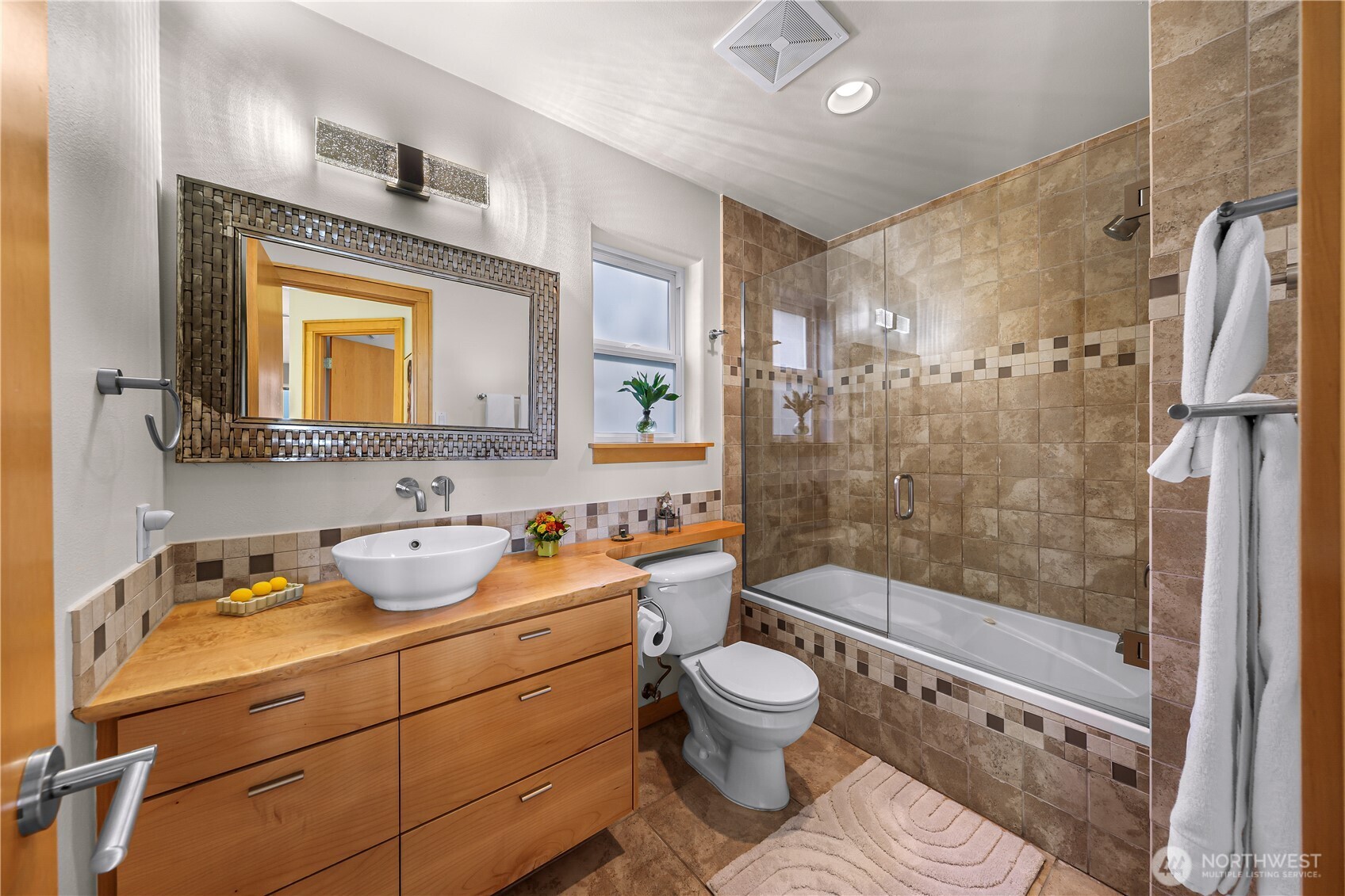 106 North State Street Bellingham, WA 98225 - Photo 25 of 34 a bathroom with a toilet sink vanity granite and shower