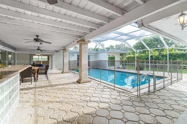 a view of a swimming pool with seating space