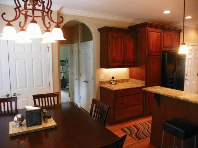 732 Heritage Road Lebanon, TN 37087 - Photo 8 of 20 a kitchen with stainless steel appliances granite countertop a sink dishwasher and a refrigerator with wooden cabinets