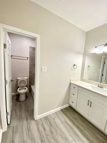 a spacious bathroom with a double vanity sink and a mirror