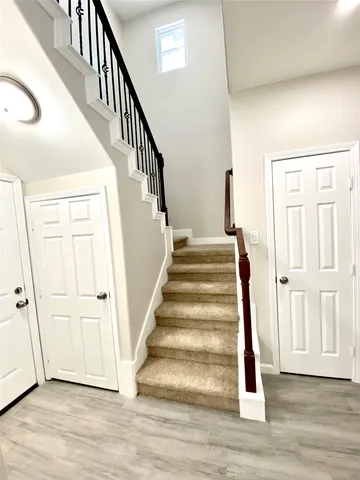 a view of an entryway with wooden floor