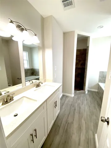a bathroom with a double vanity sink and mirror