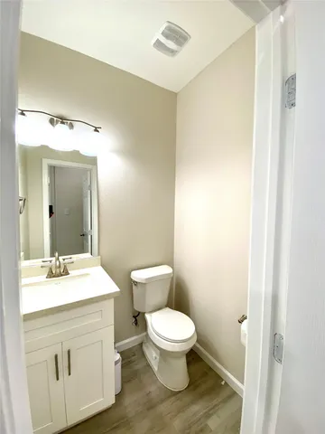 a bathroom with a toilet a sink and a mirror