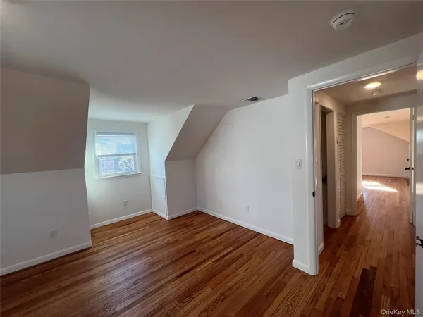 a view of hallway with wooden floor