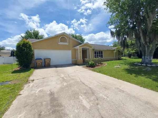 a front view of house with yard and green space