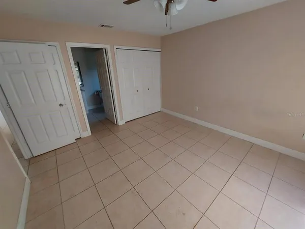an empty room with white walls and tiles