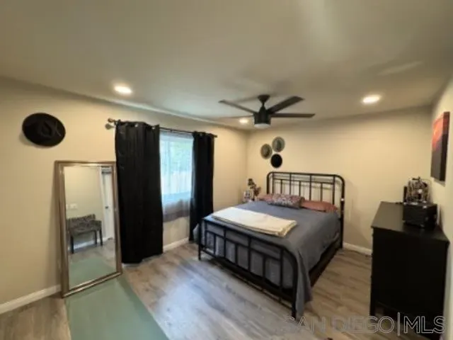 a bedroom with a bed mirror and a walk in closet