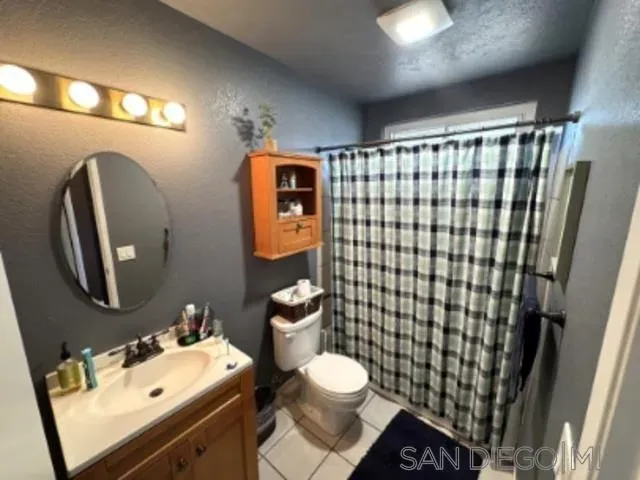 a bathroom with a sink mirror vanity and toilet