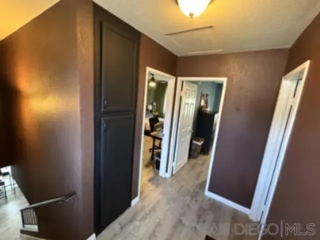 a view of a hallway and closet