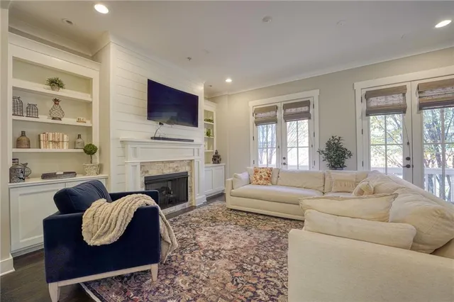 a living room with furniture a flat screen tv and a fireplace