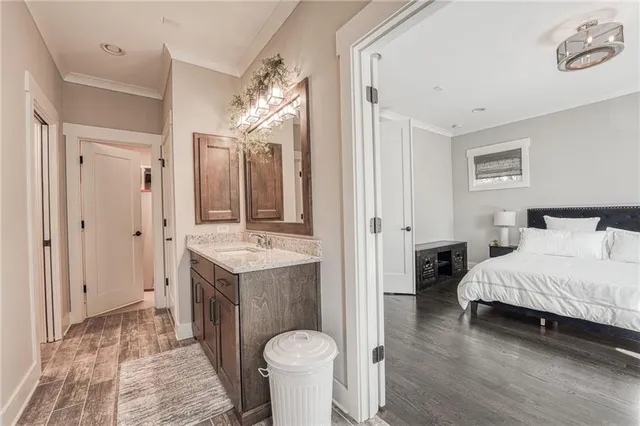 a spacious bathroom with a granite countertop sink and a mirror