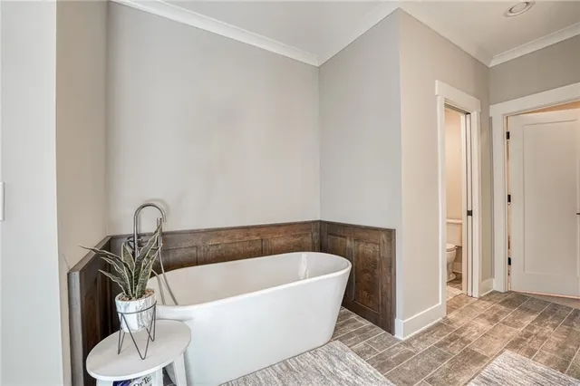 a white bath tub sitting next to a toilet