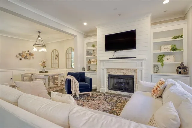 a living room with furniture fireplace and flat screen tv
