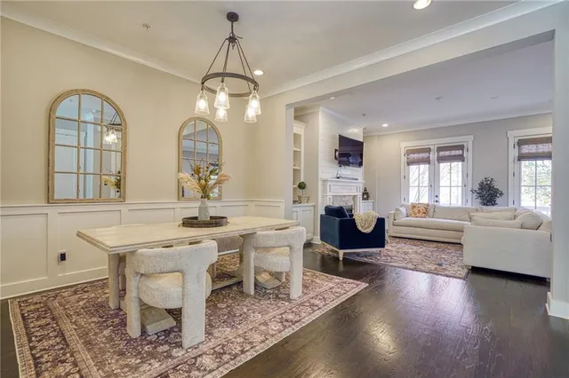 a living room with fireplace furniture and a wooden floor