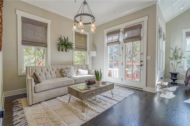 a living room with furniture and a chandelier