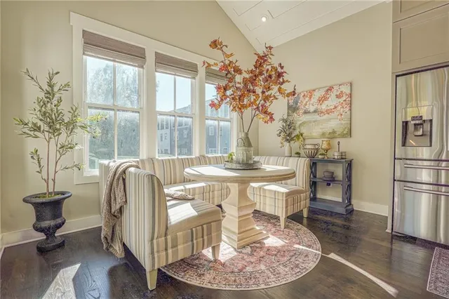 a dining room with furniture a chandelier and wooden floor