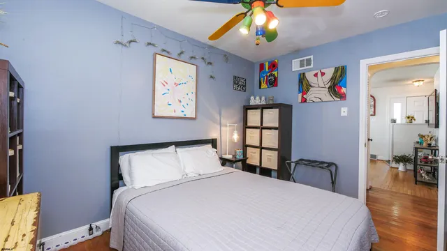 a bedroom with a bed and a chandelier