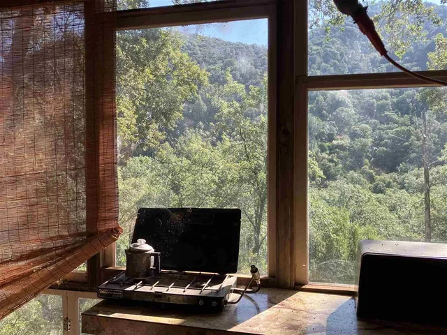 a view of balcony with wooden floor and fence