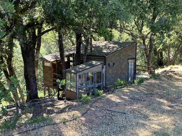 a wooden bench sitting in front of a building