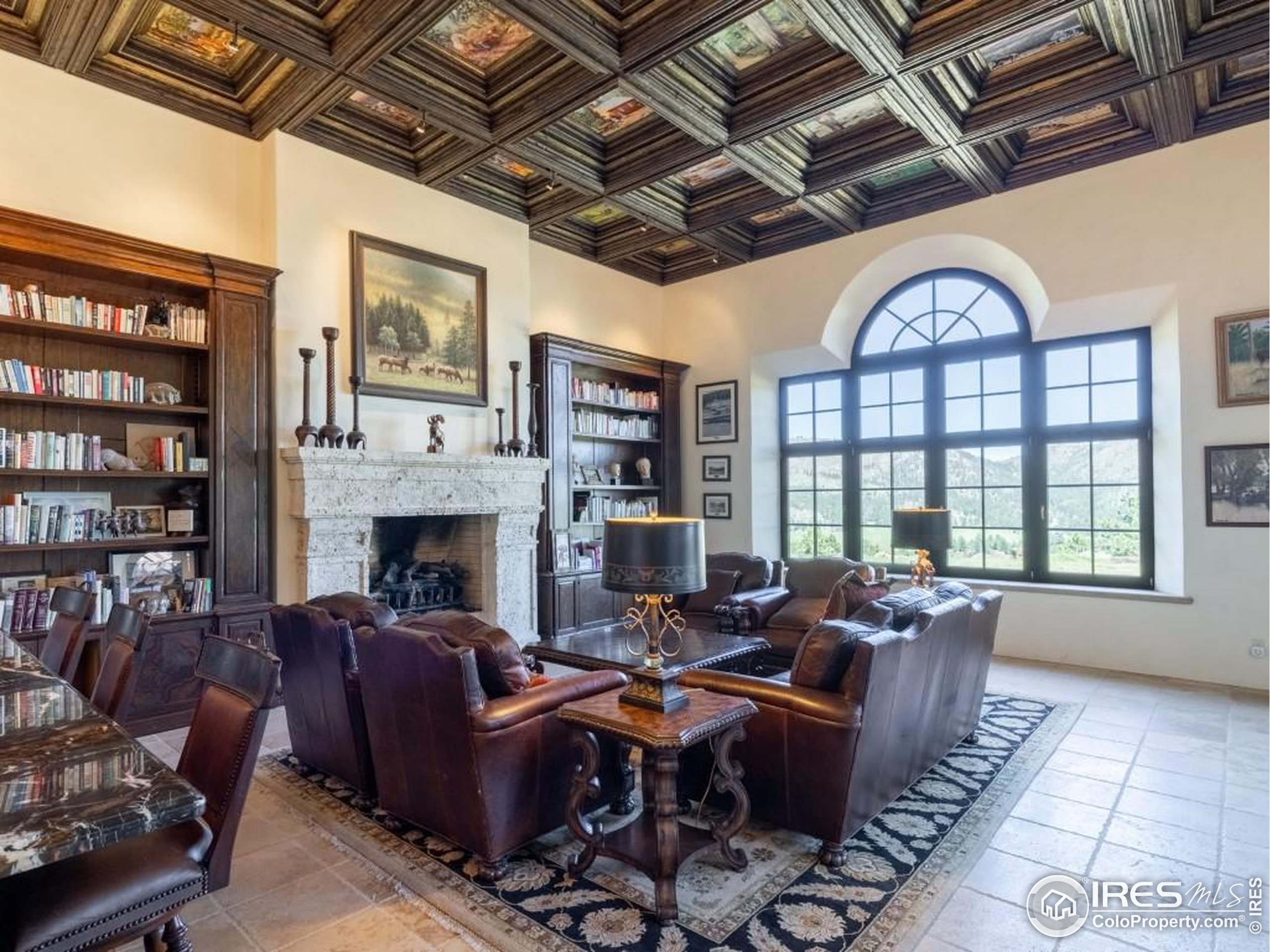 9200 Old Flowers Road Bellvue, CO 80512 - Photo 22 of 50 a living room with furniture a fireplace and a chandelier