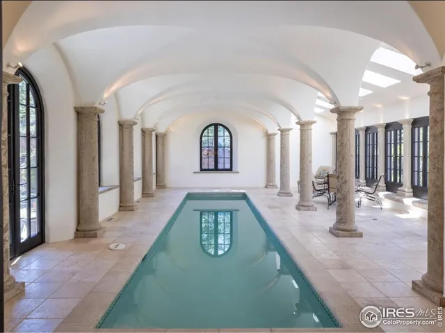 a view of an entryway with a lot of frames on wall and a window