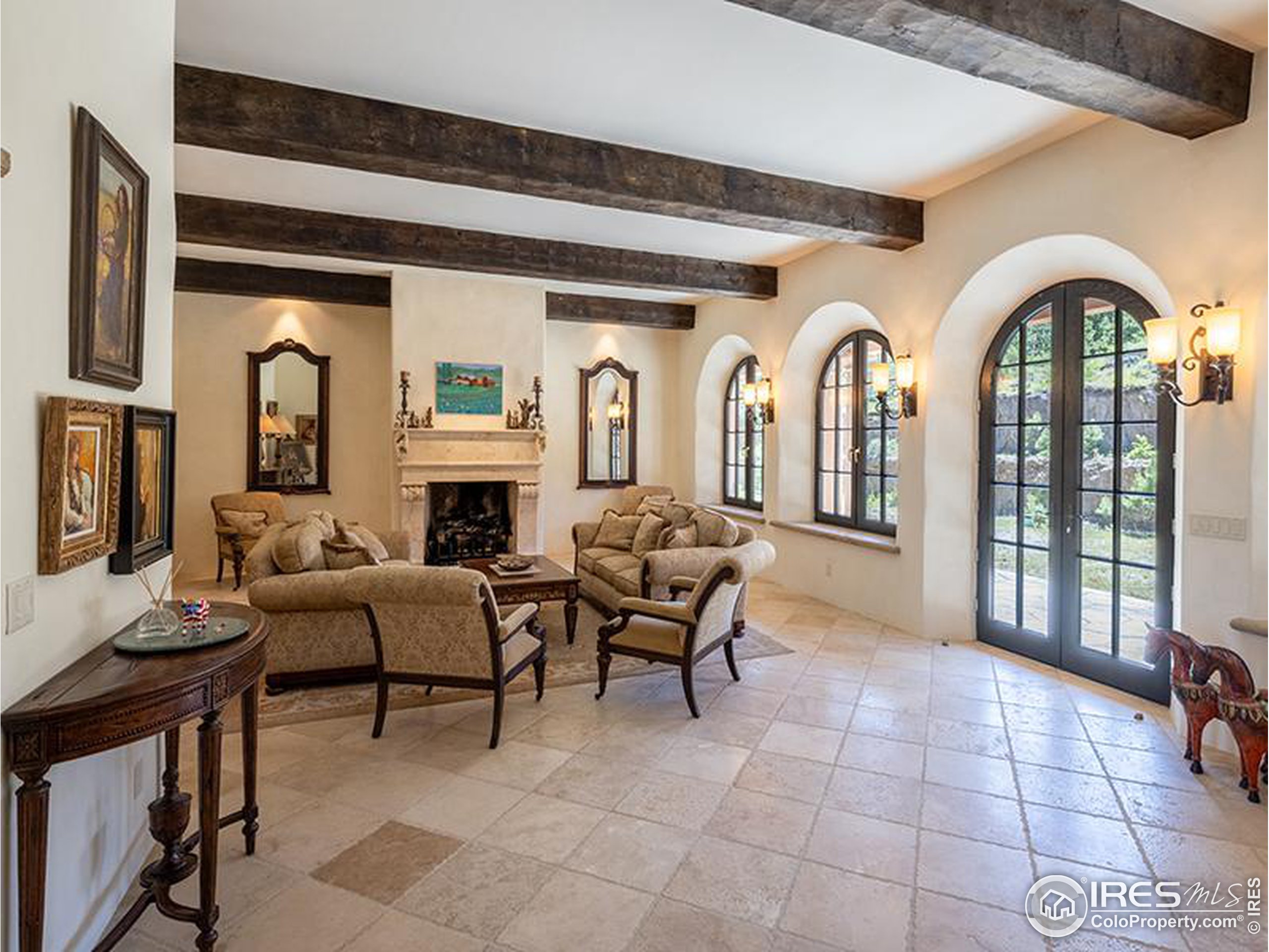 9200 Old Flowers Road Bellvue, CO 80512 - Photo 25 of 50 a living room with furniture a fireplace and a potted plant