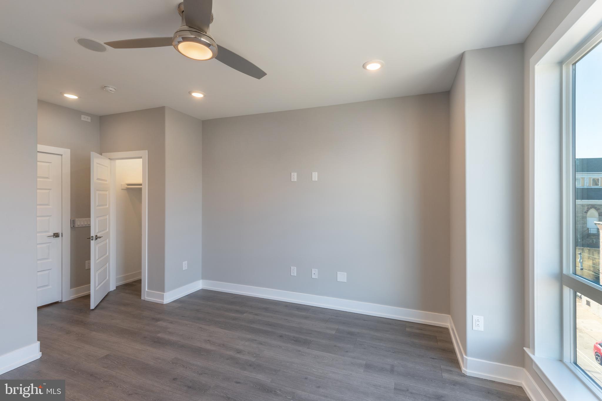 2327 North 3rd Street Philadelphia, PA 19133 - Photo 19 of 28 an empty room with wooden floor and windows