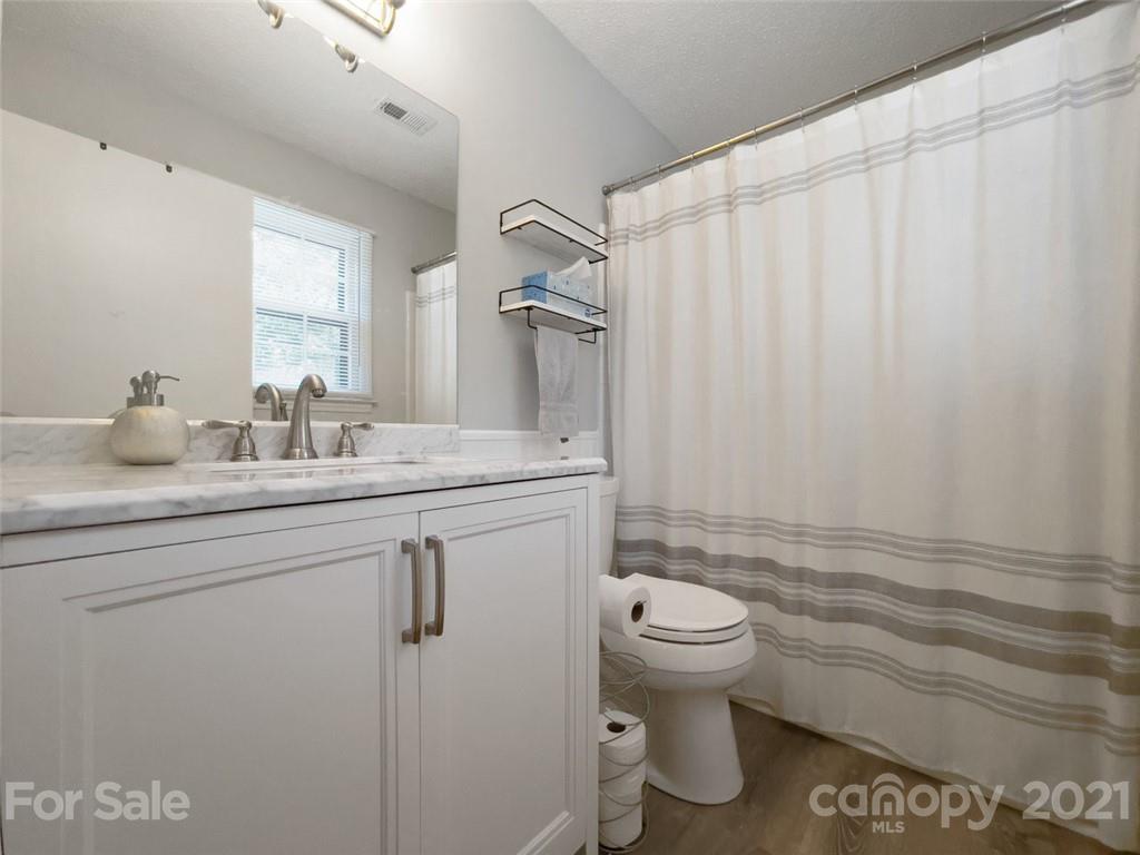10017 Sardis Oaks Road Charlotte, NC 28270 - Photo 17 of 31 a bathroom with a granite countertop sink toilet and shower