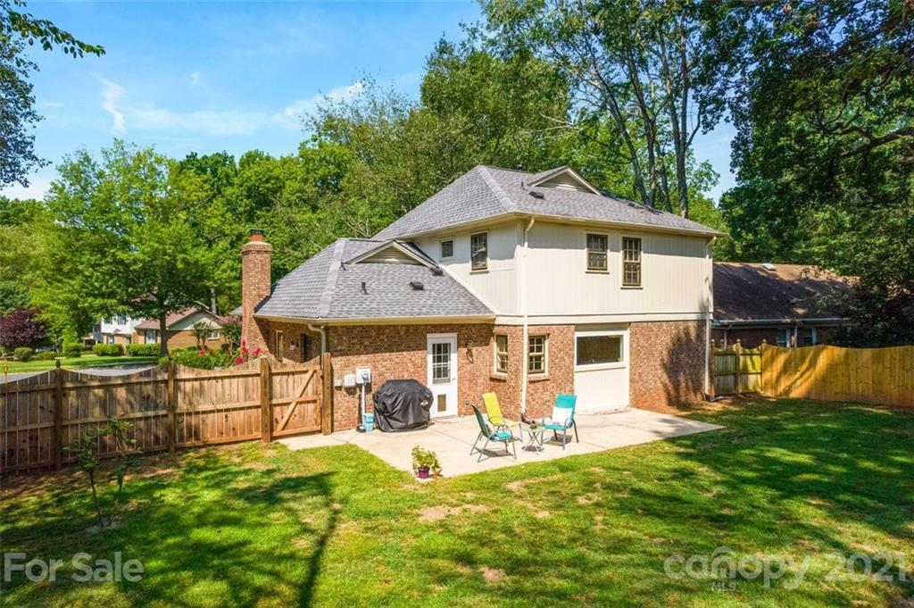 10017 Sardis Oaks Road Charlotte, NC 28270 - Photo 23 of 31 a front view of a house with a yard table and chairs