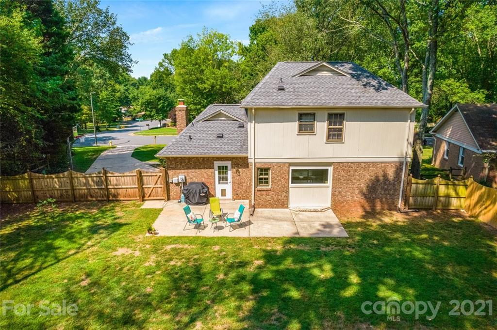 10017 Sardis Oaks Road Charlotte, NC 28270 - Photo 24 of 31 a aerial view of a house with a yard table and chairs